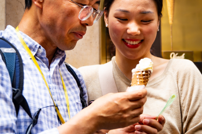 Candid family moment during a Rome vacation photo session Father and daughter sharing a gelato and smiling during a candid vacation photo session in Rome